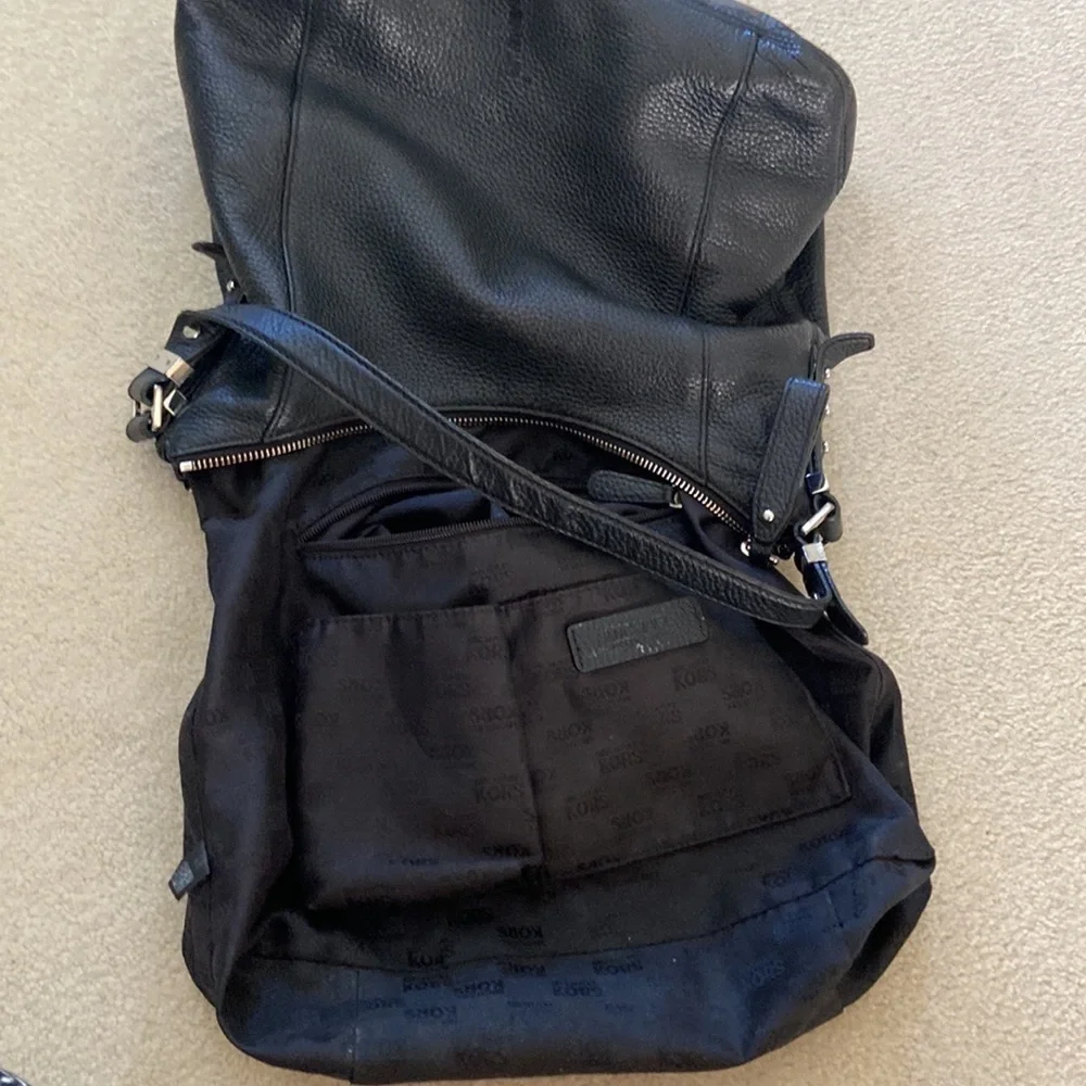 Michael Kors black leather shoulder bag, silver hardware logo on zipper, clean